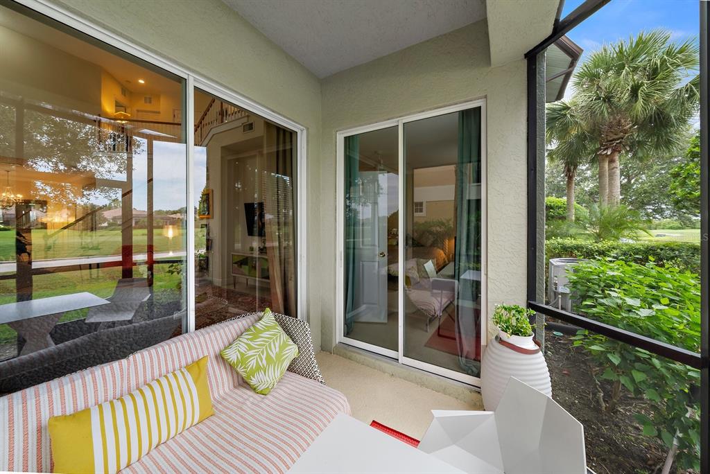 8406 Miramar Way, Unit 8406 Lakewood Ranch, FL 34202 - Photo 13 of 31 a bedroom with furniture and large windows