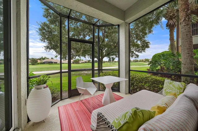 a balcony with couple of chairs and a table