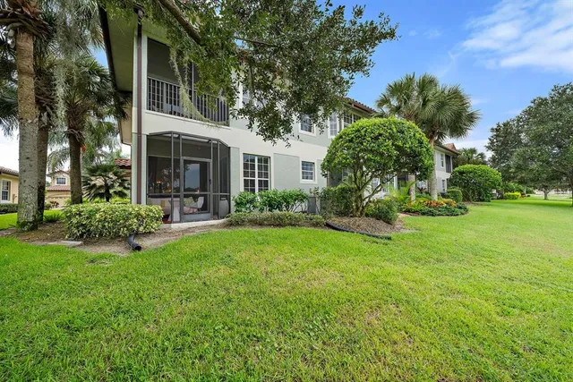 a view of backyard of house with green space