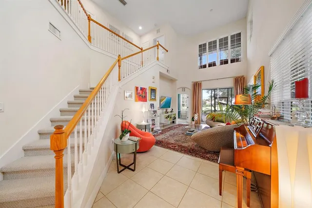 a living room with furniture a rug and white walls