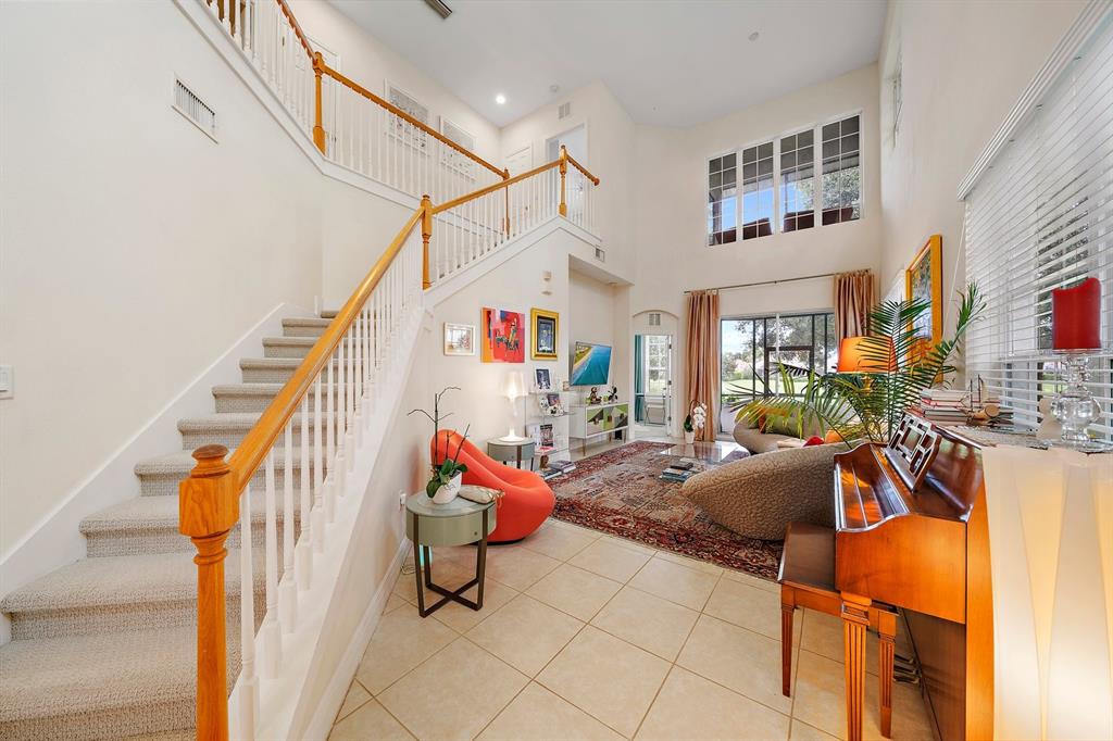 8406 Miramar Way, Unit 8406 Lakewood Ranch, FL 34202 - Photo 16 of 31 a living room with furniture a rug and white walls