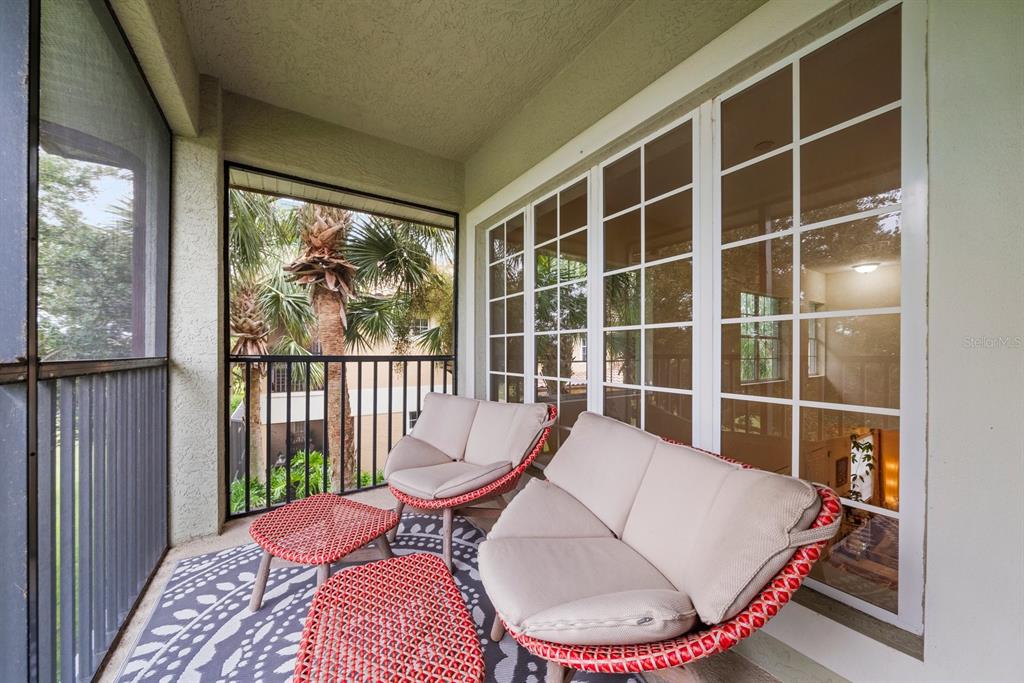 8406 Miramar Way, Unit 8406 Lakewood Ranch, FL 34202 - Photo 20 of 31 a living room with furniture and a large window