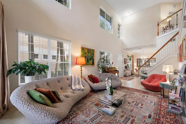 a living room with furniture and a potted plant