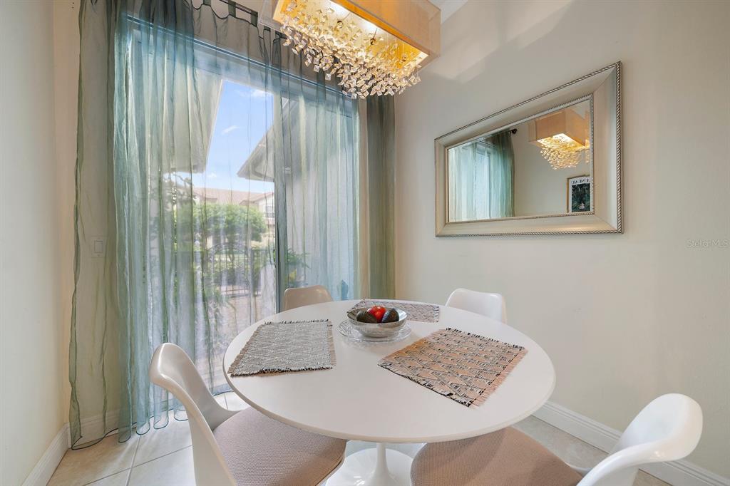 8406 Miramar Way, Unit 8406 Lakewood Ranch, FL 34202 - Photo 29 of 31 a view of a dining room with furniture and window