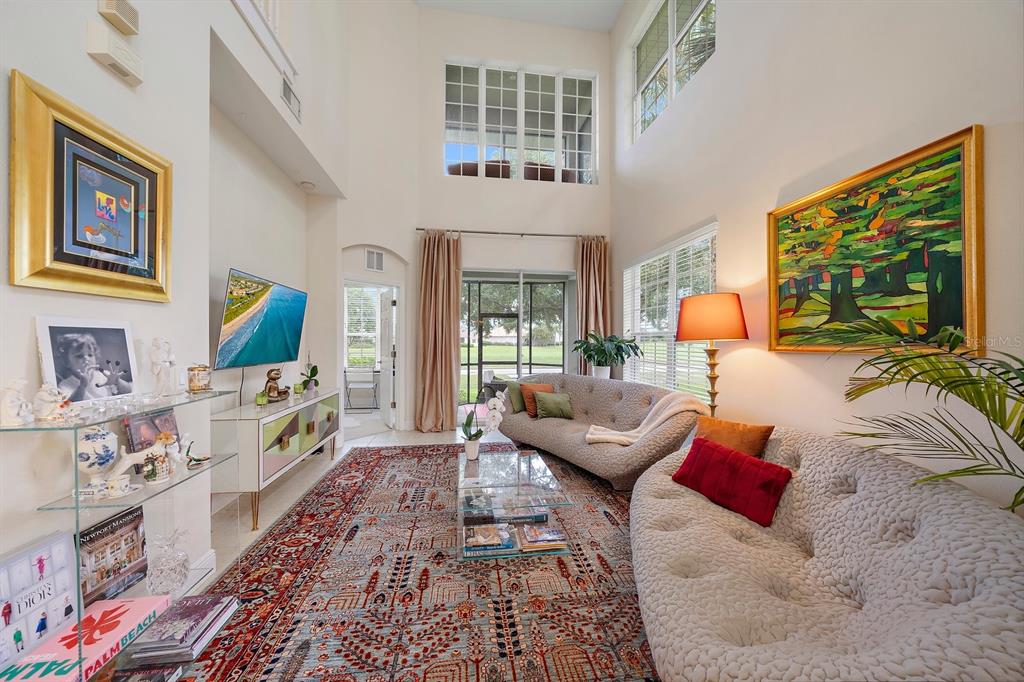 8406 Miramar Way, Unit 8406 Lakewood Ranch, FL 34202 - Photo 3 of 31 a living room with furniture and a flat screen tv