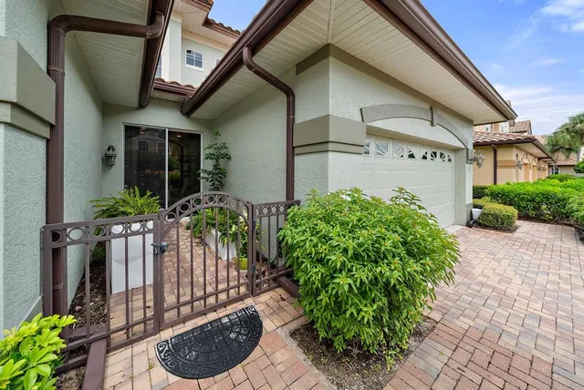 a view of a house with potted plants