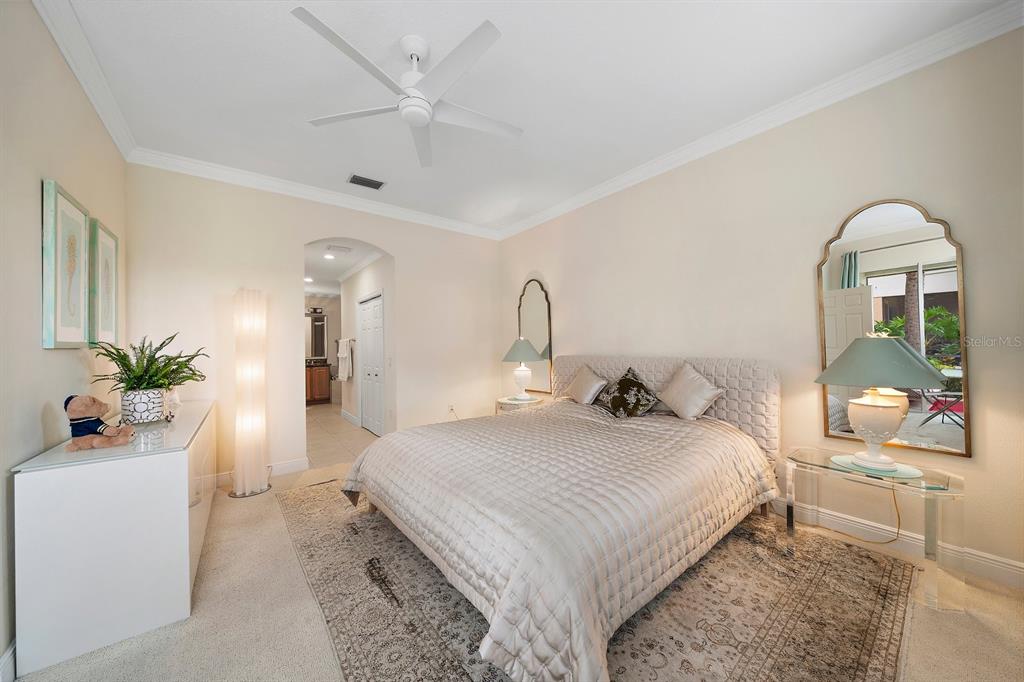 8406 Miramar Way, Unit 8406 Lakewood Ranch, FL 34202 - Photo 10 of 31 a bedroom with a bed and a potted plant