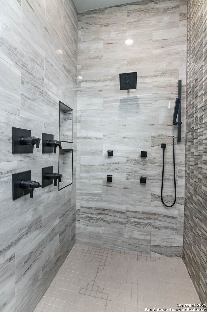 815 Brand Road Bulverde, TX 78163 - Photo 17 of 50 a bathroom with a sink and a shower