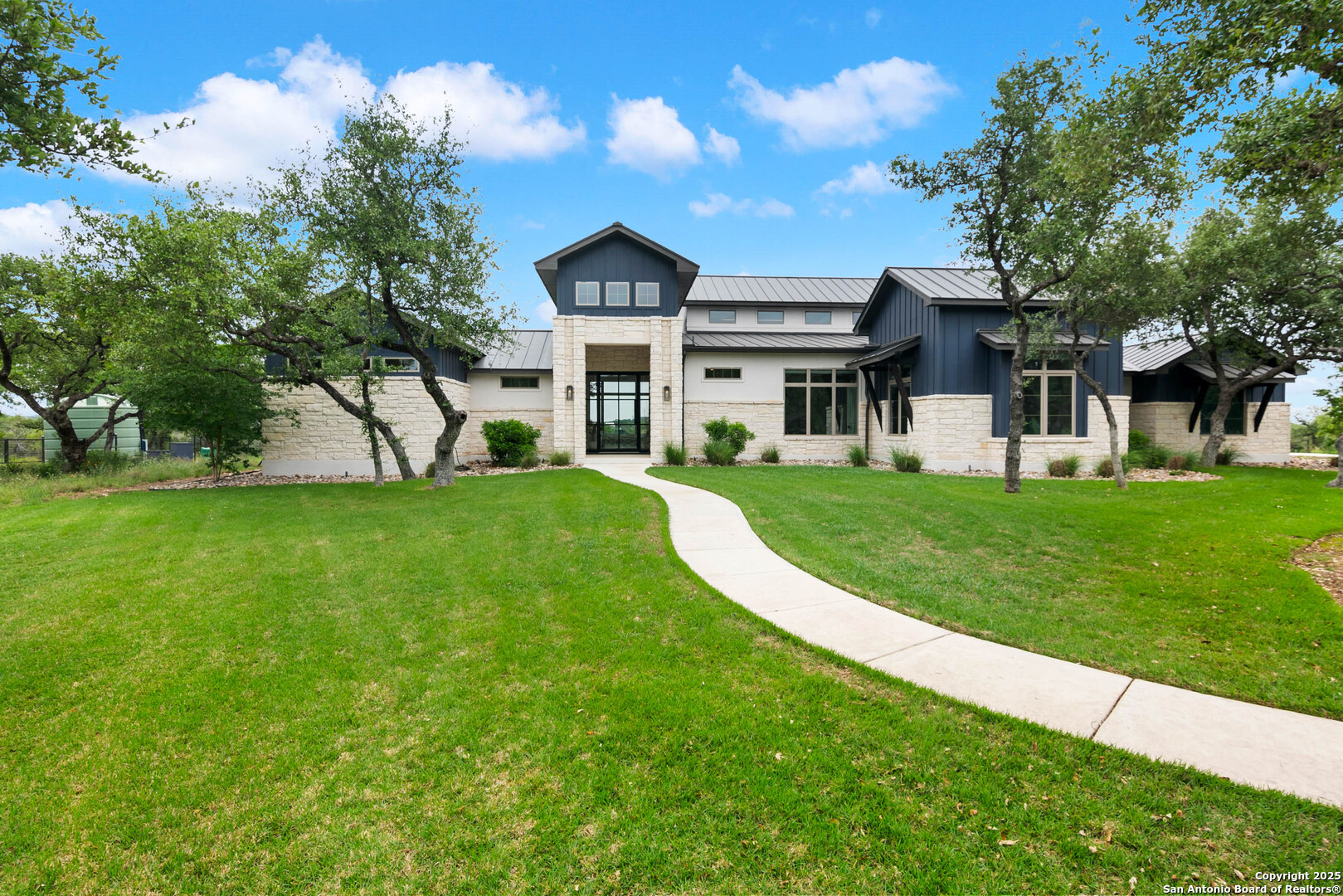 815 Brand Road Bulverde, TX 78163 - Photo 2 of 50 a view of house in front of a big yard with large trees