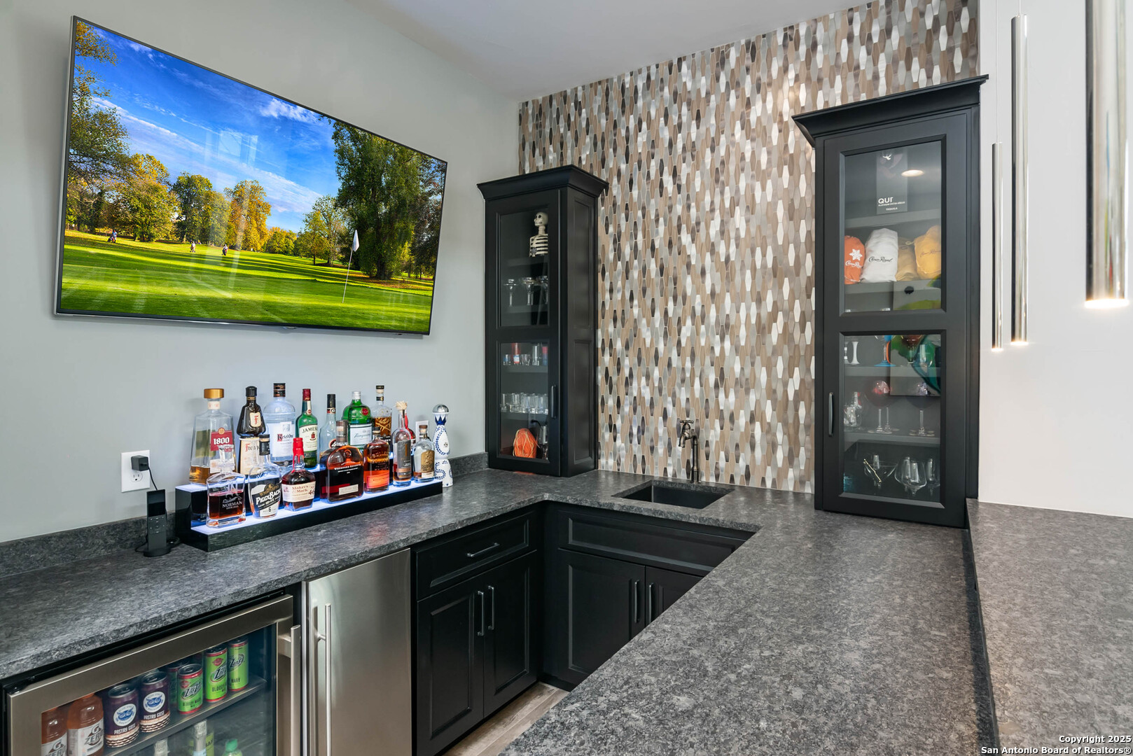 815 Brand Road Bulverde, TX 78163 - Photo 24 of 50 a kitchen with stainless steel appliances kitchen island granite countertop a refrigerator and a sink
