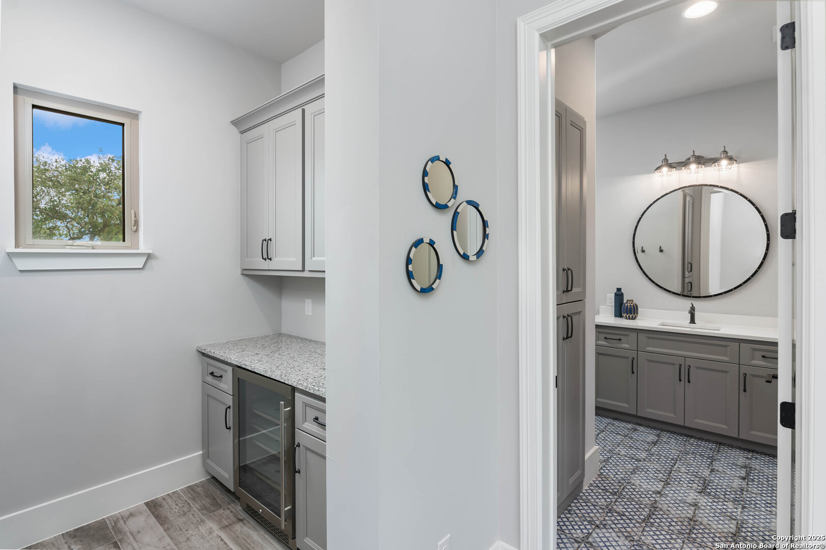 815 Brand Road Bulverde, TX 78163 - Photo 26 of 50 a bathroom with a granite countertop sink a mirror and a window