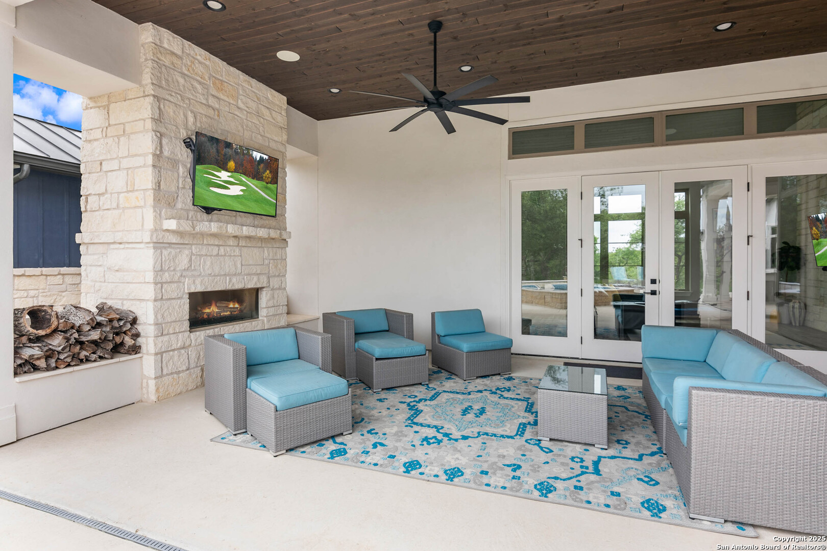 815 Brand Road Bulverde, TX 78163 - Photo 36 of 50 a living room with furniture a flat screen tv and a fireplace
