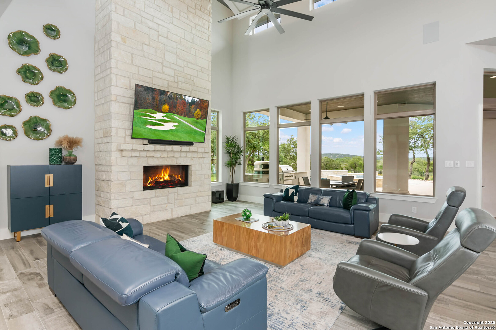 815 Brand Road Bulverde, TX 78163 - Photo 7 of 50 a living room with furniture a flat screen tv and a fireplace