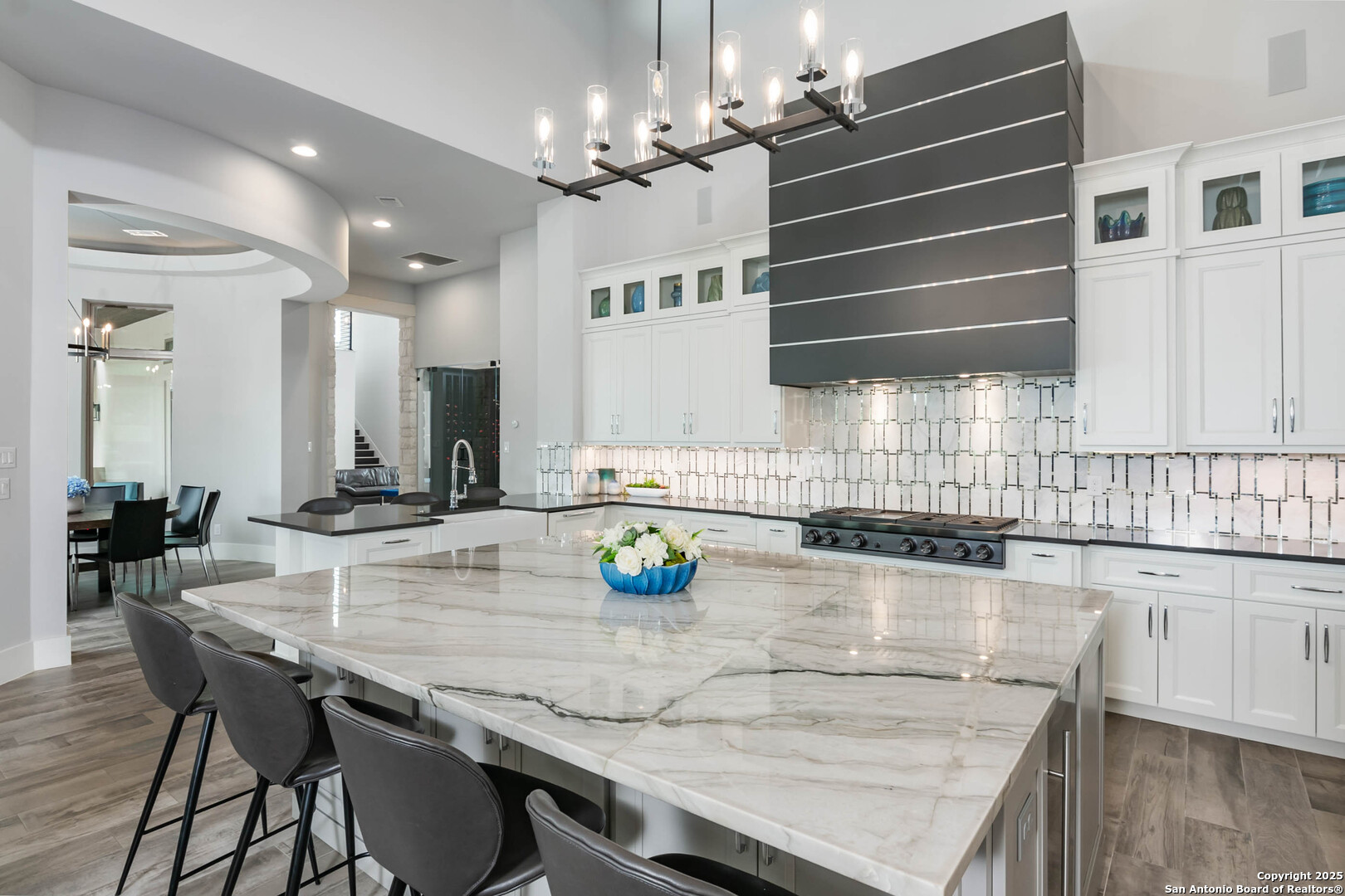 815 Brand Road Bulverde, TX 78163 - Photo 10 of 50 a kitchen with kitchen island granite countertop a table chairs sink and cabinets
