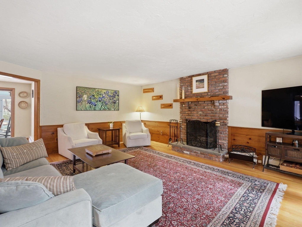 10 Berkeley Lane Andover, MA 01810 - Photo 11 of 42 a living room with furniture flat screen tv and a fireplace