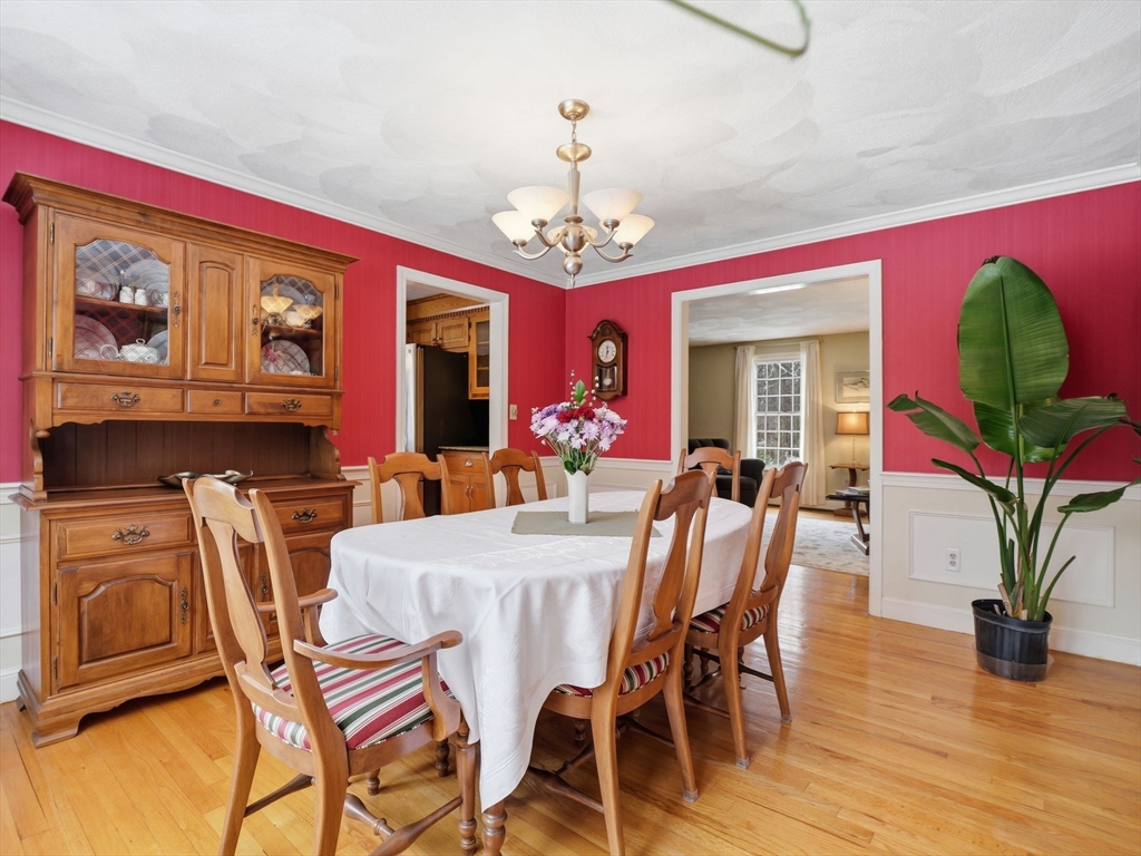 10 Berkeley Lane Andover, MA 01810 - Photo 19 of 42 a view of a dining room with furniture a chandelier and wooden floor