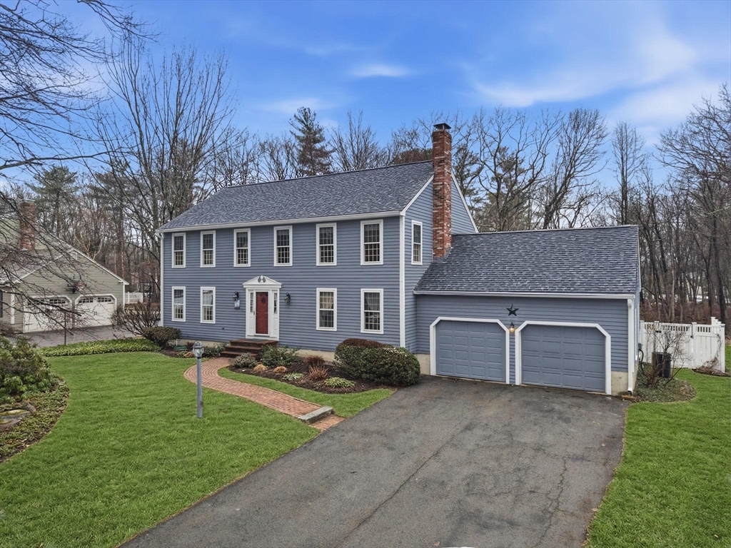10 Berkeley Lane Andover, MA 01810 - Photo 2 of 42 a front view of a house with a garden and plants