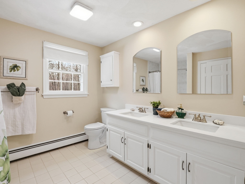 10 Berkeley Lane Andover, MA 01810 - Photo 21 of 42 a bathroom with a double vanity sink toilet and mirror