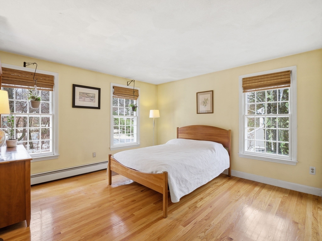 10 Berkeley Lane Andover, MA 01810 - Photo 30 of 42 a spacious bedroom with a bed and wooden floor