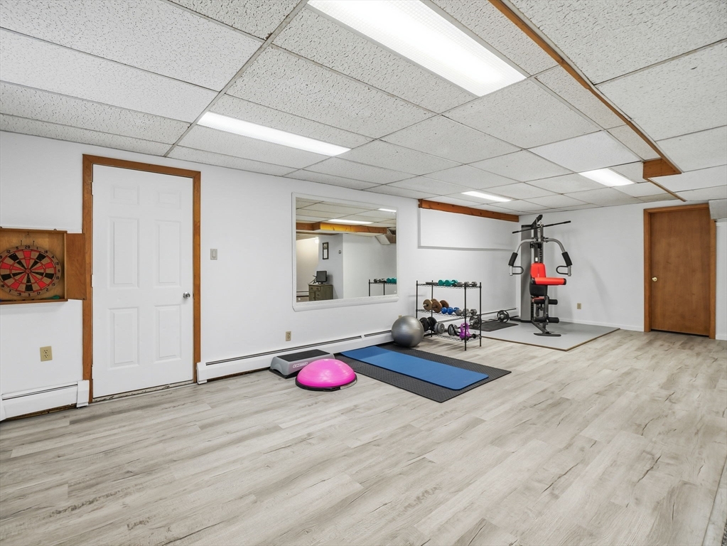 10 Berkeley Lane Andover, MA 01810 - Photo 37 of 42 a view of a room with gym equipment and wooden floor