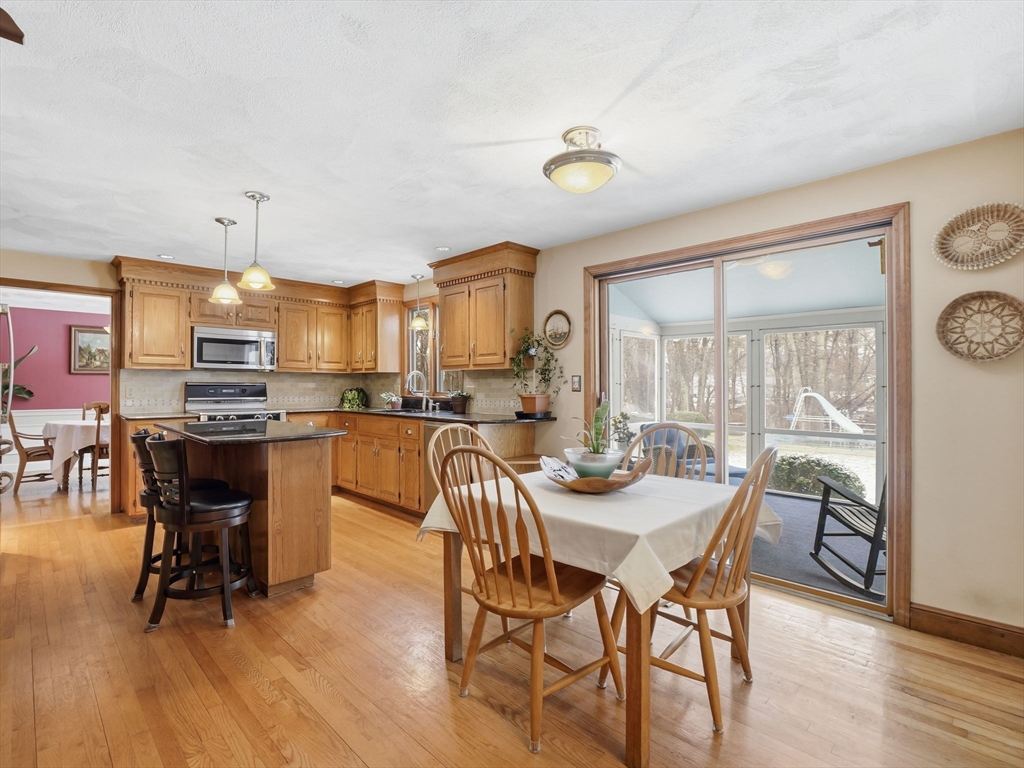 10 Berkeley Lane Andover, MA 01810 - Photo 4 of 42 a view of a dining room with furniture and wooden floor