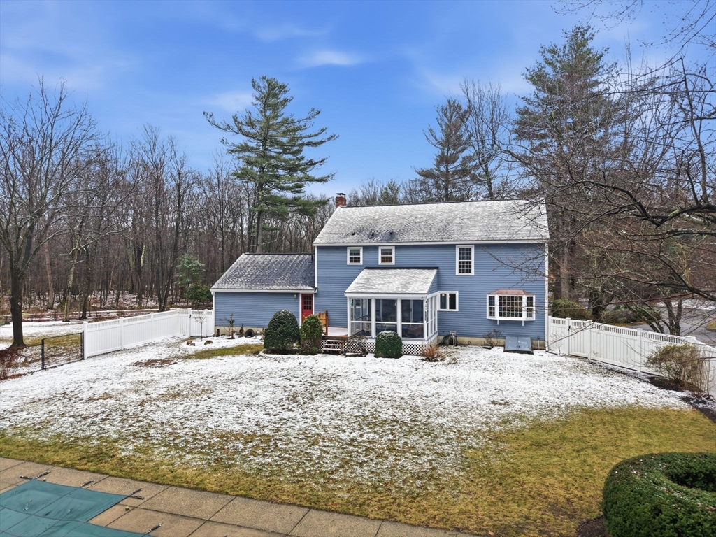 10 Berkeley Lane Andover, MA 01810 - Photo 41 of 42 a front view of a house with a yard covered with snow and trees
