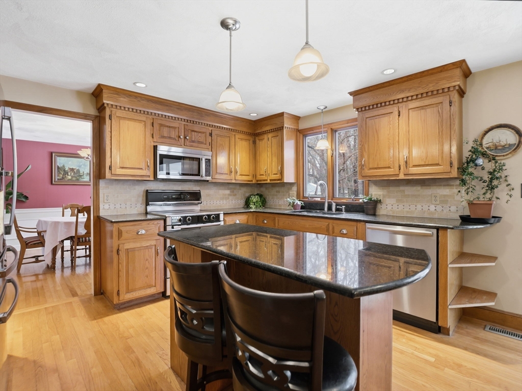 10 Berkeley Lane Andover, MA 01810 - Photo 5 of 42 a kitchen with a stove a sink and a refrigerator