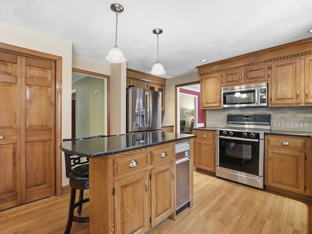 10 Berkeley Lane Andover, MA 01810 - Photo 6 of 42 a kitchen with stainless steel appliances granite countertop a stove a sink and a refrigerator