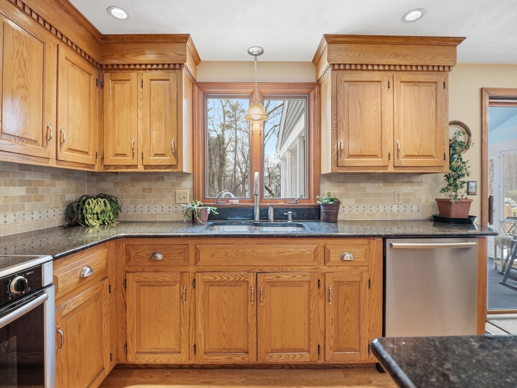 10 Berkeley Lane Andover, MA 01810 - Photo 8 of 42 a kitchen with granite countertop a sink stainless steel appliances and cabinets