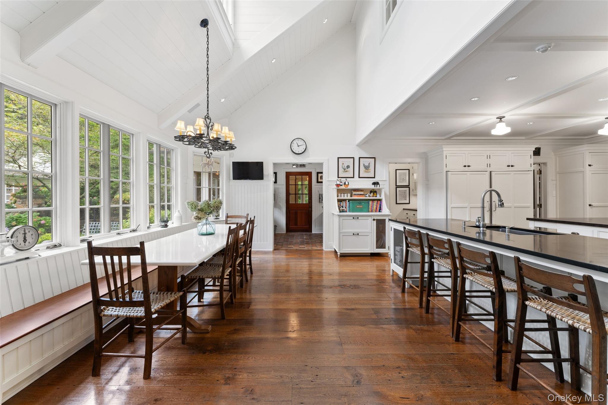 65 Garden Road Scarsdale, NY 10583 - Photo 20 of 48 a view of a dining room and livingroom with furniture wooden floor a chandelier