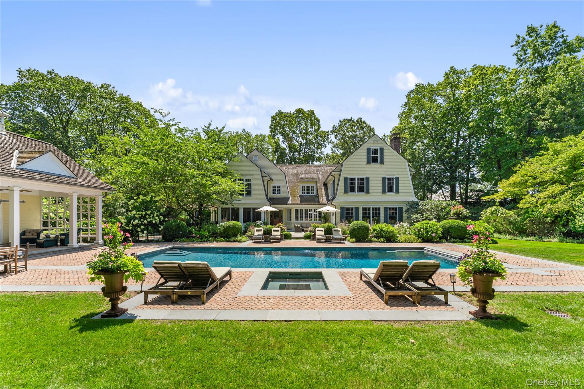 65 Garden Road Scarsdale, NY 10583 - Photo 2 of 48 a view of a house with swimming pool and sitting area