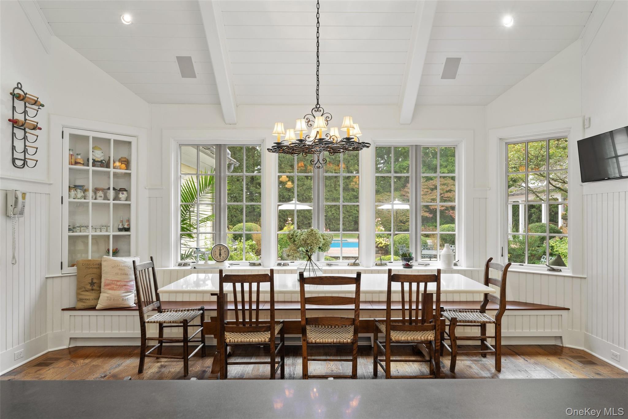 65 Garden Road Scarsdale, NY 10583 - Photo 21 of 48 a dining room with furniture a chandelier and wooden floor