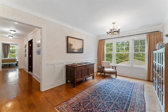 a bedroom with a bed couch and a large window