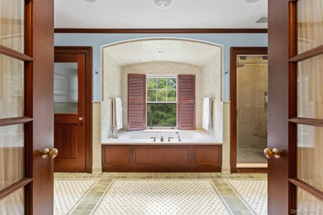 a spacious bathroom with a granite countertop sink and a mirror
