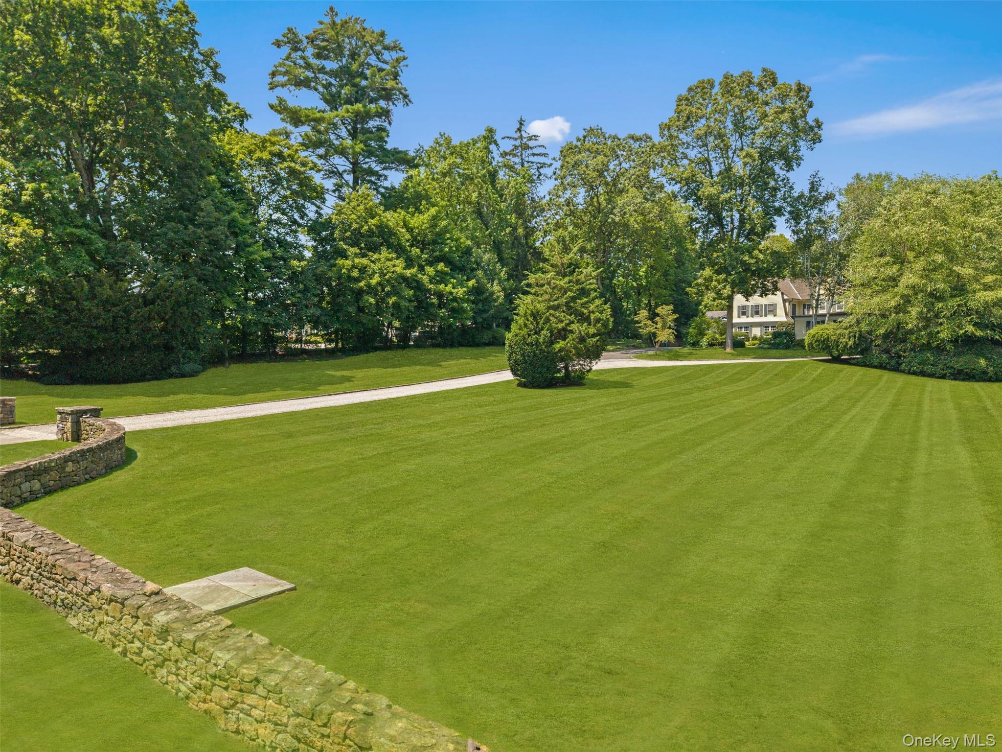 65 Garden Road Scarsdale, NY 10583 - Photo 5 of 48 a view of a big yard with a large trees