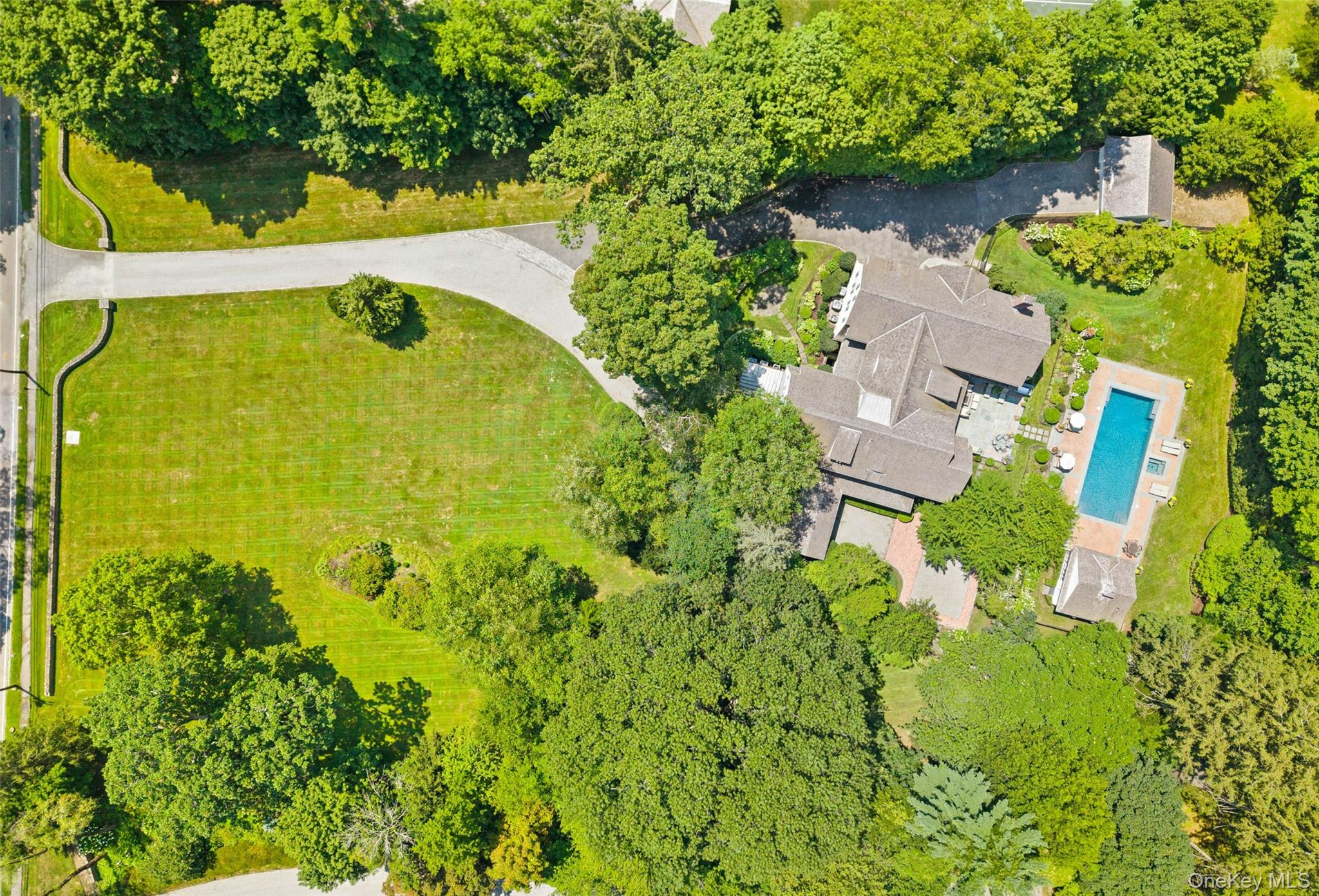 65 Garden Road Scarsdale, NY 10583 - Photo 6 of 48 an aerial view of a house with swimming pool and garden