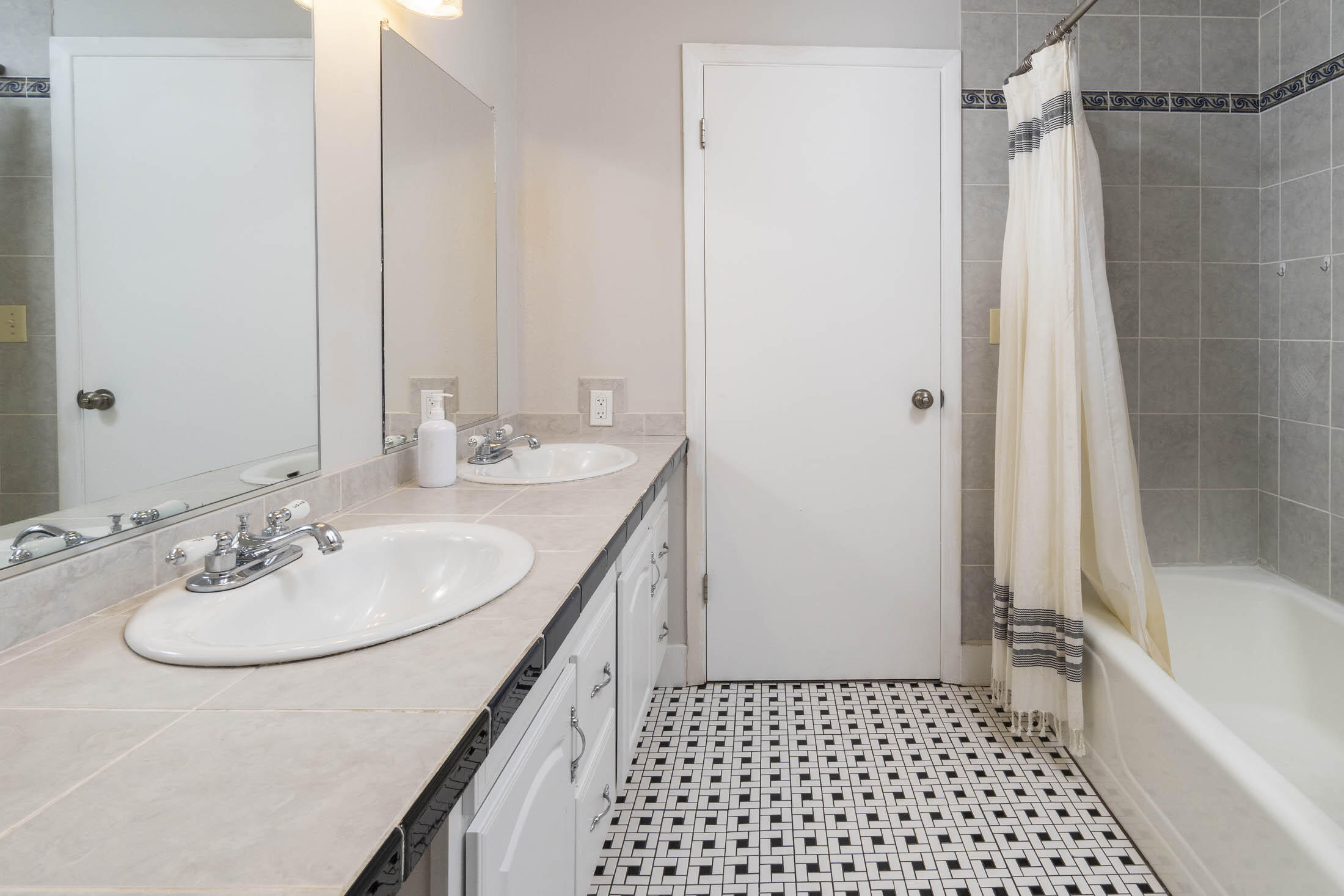 61139 Parrell Road Bend, OR 97702 - Photo 9 of 16 Large bathroom with double vanity, tile surround and floors