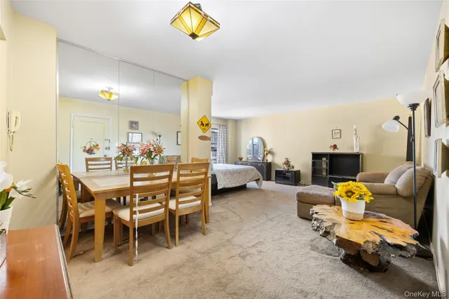 a dining room with furniture and a chandelier