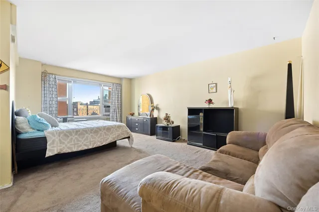 a bedroom with bed and a couch