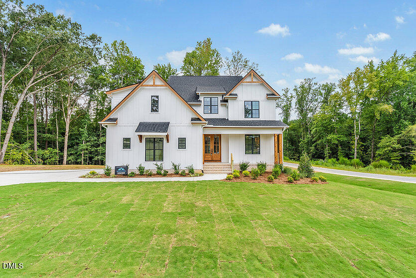 a front view of house with yard and green space