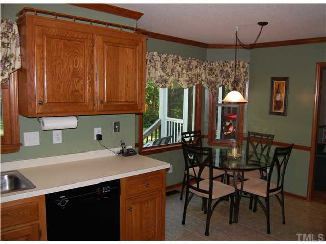 608 South Meadow Road Raleigh, NC 27603 - Photo 11 of 25 a kitchen with a sink cabinets and wooden floor