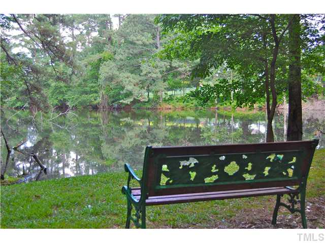 608 South Meadow Road Raleigh, NC 27603 - Photo 7 of 25 a wooden bench sitting in the middle of a yard