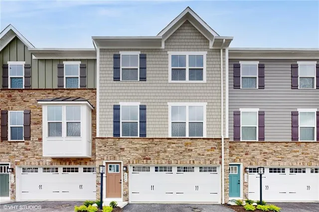 a front view of a house with large windows