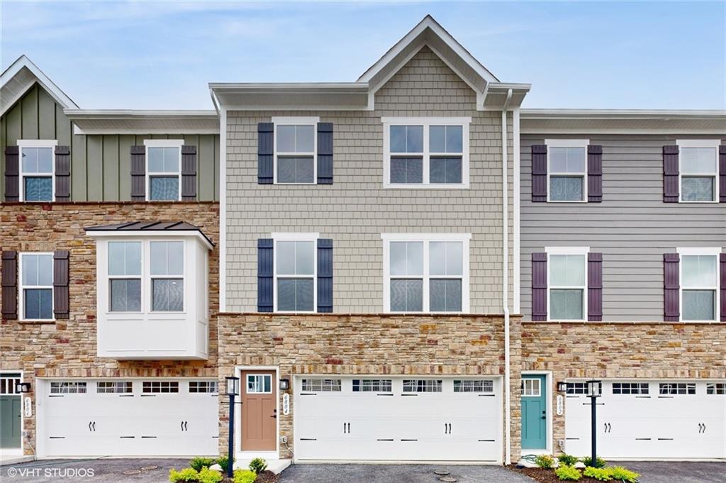 a front view of a house with large windows