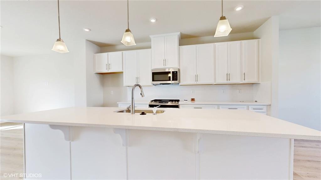 6804 Sycamore Way Gibsonia, PA 15044 - Photo 14 of 50 a kitchen with stainless steel appliances a stove a sink a microwave a refrigerator and white cabinets