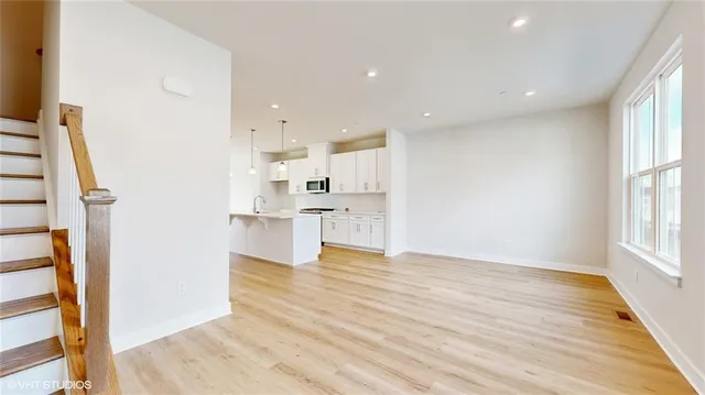 a living room with furniture a rug and a flat screen tv
