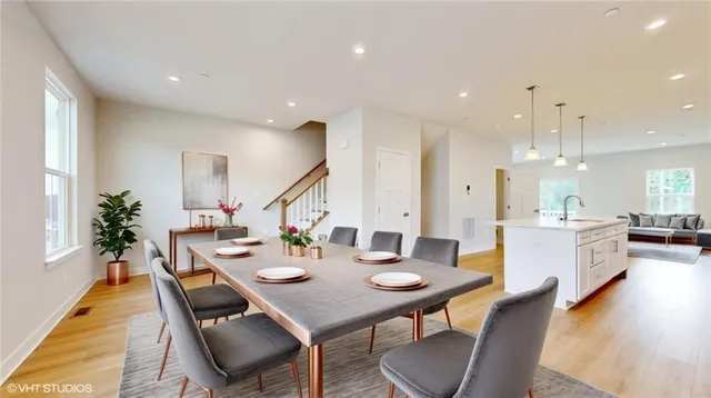 a view of a dining room with furniture and wooden floor