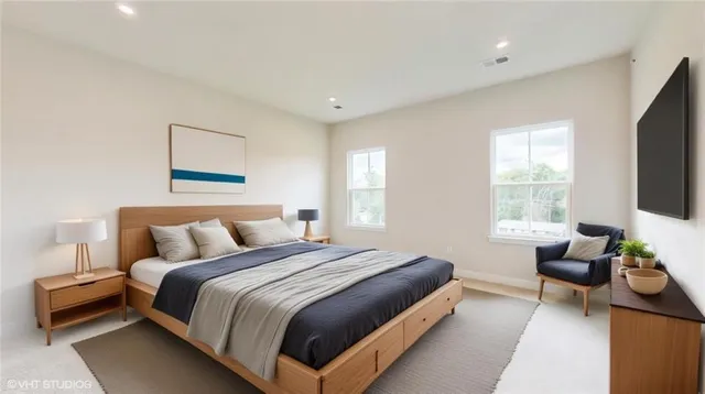 a bedroom with a bed and a flat screen tv