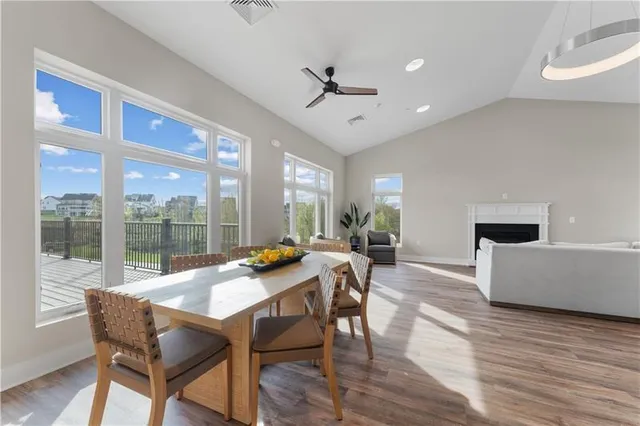 a kitchen with refrigerator cabinets dining table and wooden floor