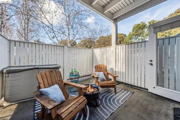 a view of a house with a yard and sitting area